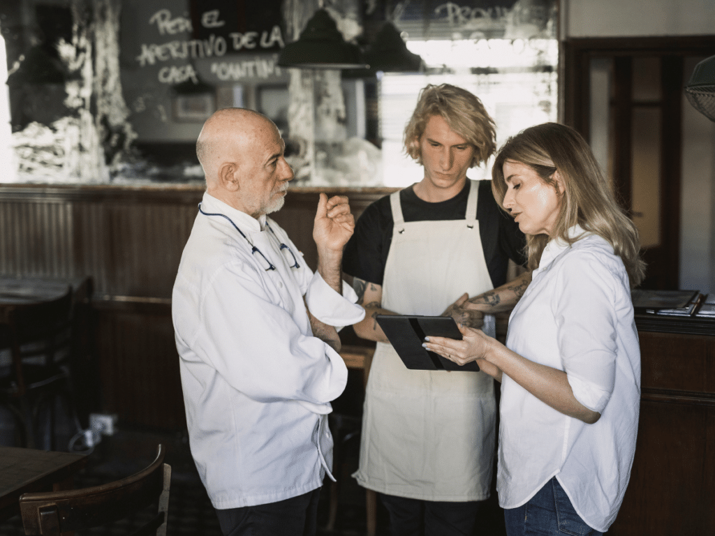 Server and management having a team meeting at a restaurant